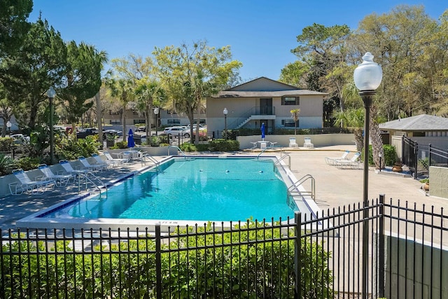 pool with fence and a patio area