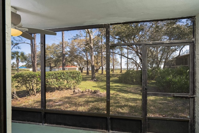 unfurnished sunroom with plenty of natural light and ceiling fan