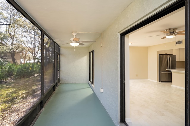 sunroom / solarium with visible vents and ceiling fan