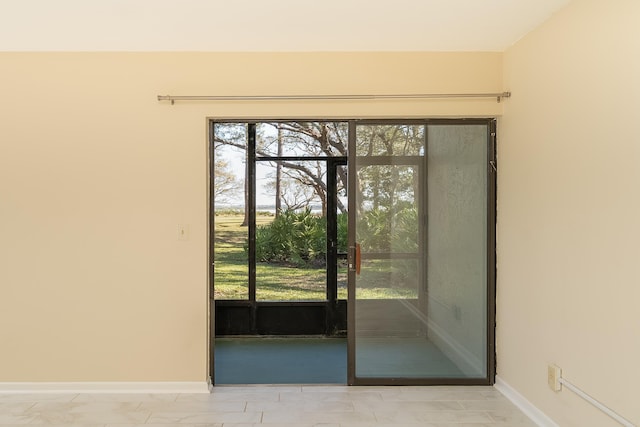 doorway with a healthy amount of sunlight and baseboards