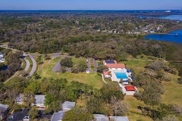 birds eye view of property with a view of trees and a water view