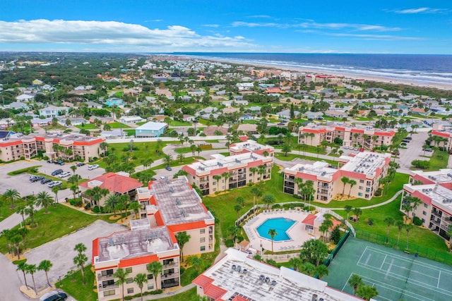 drone / aerial view featuring a water view and a beach view