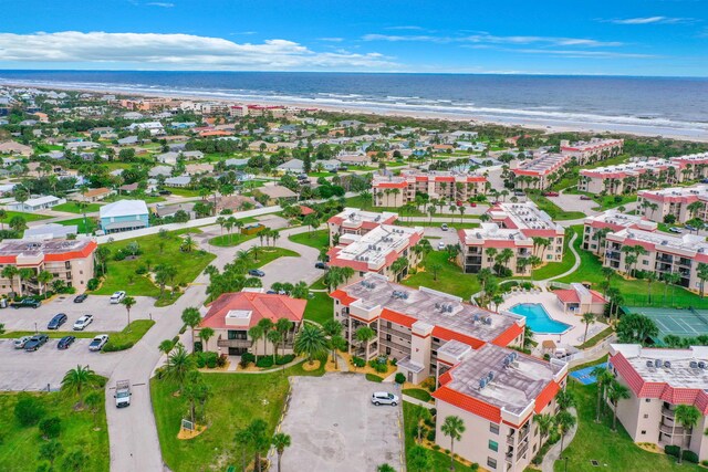 birds eye view of property with a water view and a view of the beach