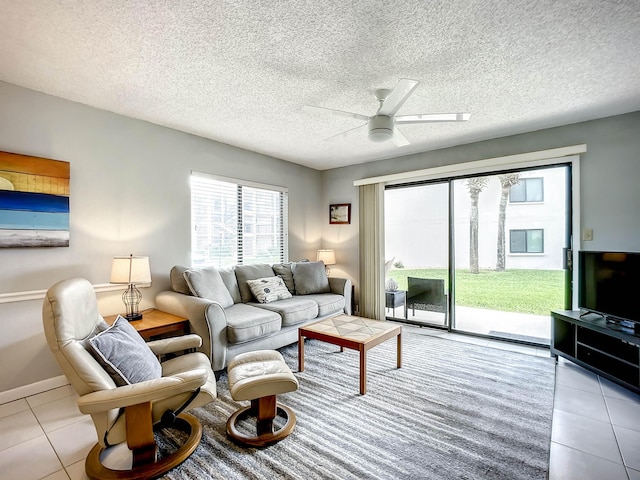 tiled living room with a textured ceiling and ceiling fan