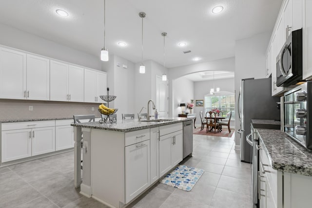 279 Spring Creek Way, Saint Augustine, FL 32095 - kitchen with appliances with stainless steel finishes, arched walkways, white cabinets, and recessed lighting