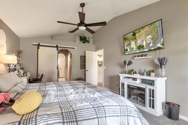 3010 SE 46th Ave, Ocala, FL 34480 - carpeted bedroom featuring arched walkways, vaulted ceiling, baseboards, a fireplace, and ceiling fan