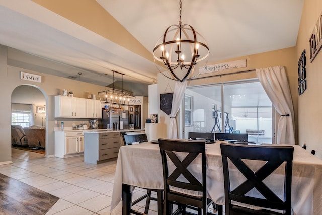 3010 SE 46th Ave, Ocala, FL 34480 - dining space with a chandelier, lofted ceiling, arched walkways, and light tile patterned floors