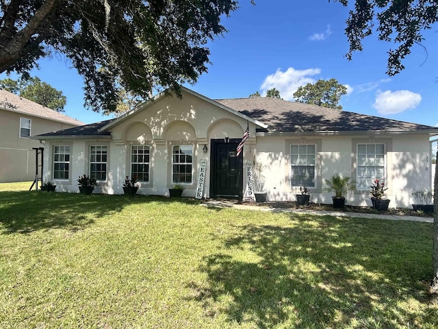 3010 SE 46th Ave, Ocala, FL 34480 - ranch-style house with stucco siding, a front yard, and a shingled roof