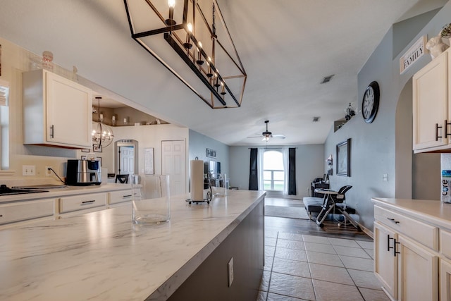 3010 SE 46th Ave, Ocala, FL 34480 - kitchen featuring a chandelier, arched walkways, a ceiling fan, white cabinets, and open floor plan
