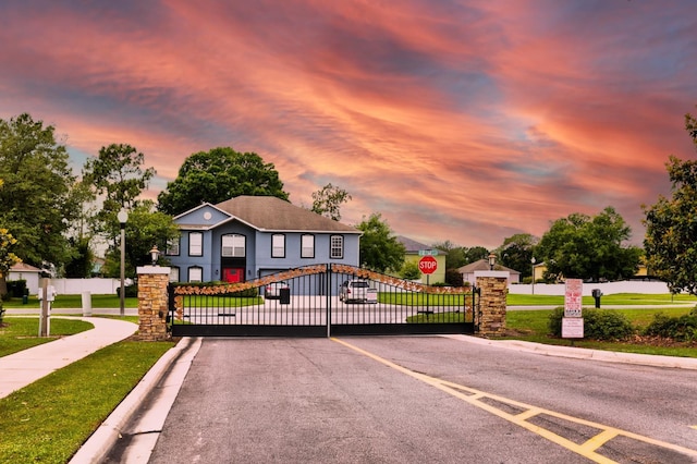 3010 SE 46th Ave, Ocala, FL 34480 - view of asphalt road with traffic signs, sidewalks, a gate, curbs, and a gated entry