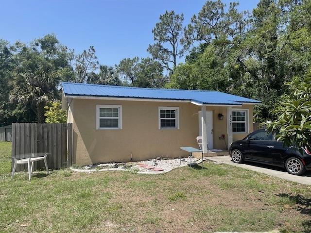 507 S Anderson St, Bunnell, FL 32110 - bungalow-style house featuring stucco siding and metal roof