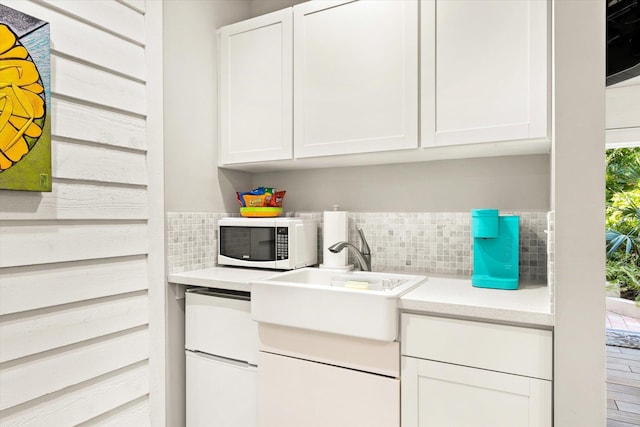 clothes washing area featuring sink and wood-type flooring