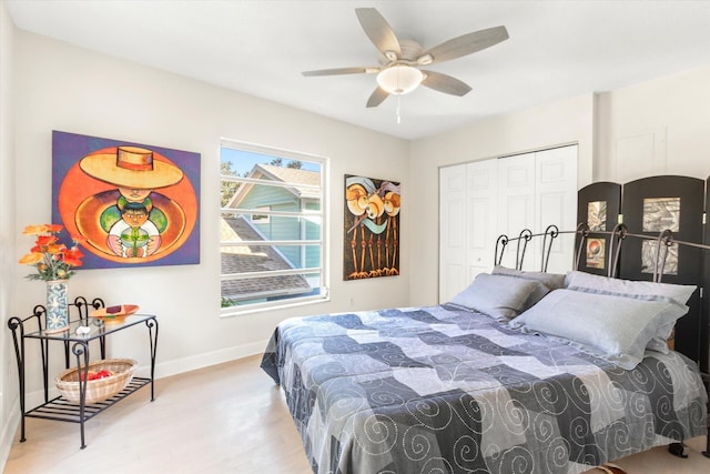 bedroom featuring ceiling fan, light wood-type flooring, and a closet