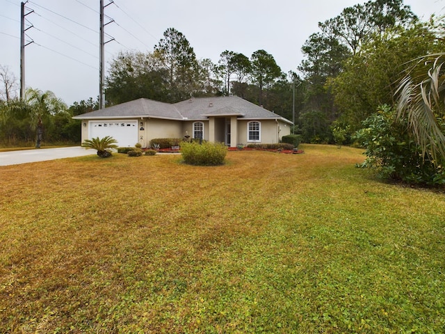 single story home featuring a garage and a front yard