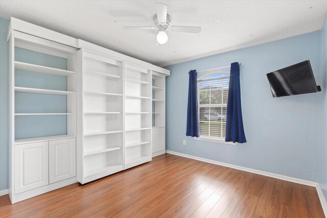 bedroom with dark hardwood / wood-style floors, a closet, and ceiling fan