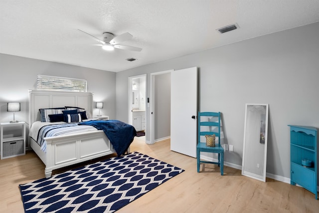 bedroom with visible vents, light wood-style flooring, and baseboards