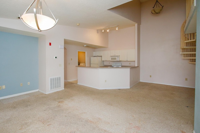 21201 Harbour Vista Cir, Saint Augustine, FL 32080 - unfurnished living room featuring light carpet, track lighting, a textured ceiling, and high vaulted ceiling