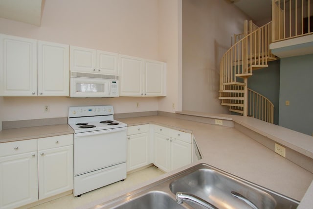 21201 Harbour Vista Cir, Saint Augustine, FL 32080 - kitchen with white appliances, white cabinets, and light countertops