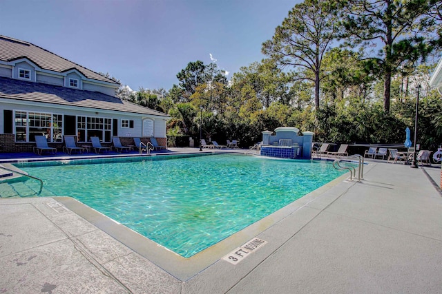 21201 Harbour Vista Cir, Saint Augustine, FL 32080 - community pool featuring a patio and view of scattered trees