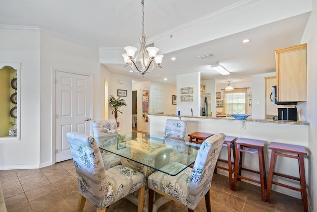 264 Gibraltar Ct Unit 102, Saint Augustine, FL 32080 - dining space with a chandelier, ornamental molding, recessed lighting, and tile patterned flooring