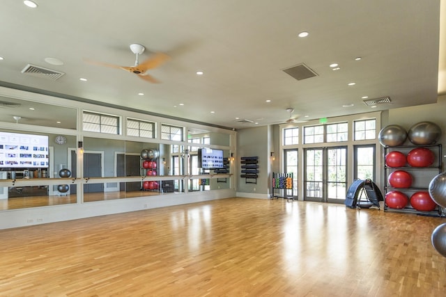 exercise area with light hardwood / wood-style flooring, ceiling fan, and french doors