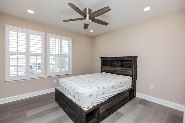 bedroom featuring hardwood / wood-style floors and ceiling fan