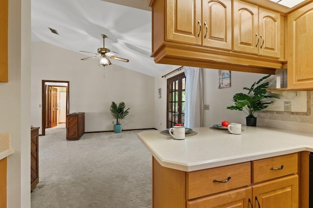 36 Lee Dr, Saint Augustine, FL 32080 - kitchen featuring vaulted ceiling, light carpet, a ceiling fan, light countertops, and a peninsula