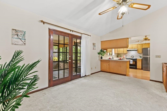 36 Lee Dr, Saint Augustine, FL 32080 - kitchen with freestanding refrigerator, french doors, ceiling fan, lofted ceiling, and black electric range