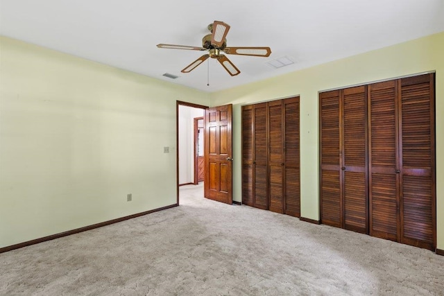 36 Lee Dr, Saint Augustine, FL 32080 - unfurnished bedroom featuring multiple closets, carpet flooring, baseboards, and a ceiling fan