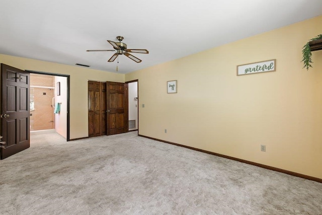 36 Lee Dr, Saint Augustine, FL 32080 - unfurnished bedroom featuring baseboards, light colored carpet, ceiling fan, and ensuite bathroom
