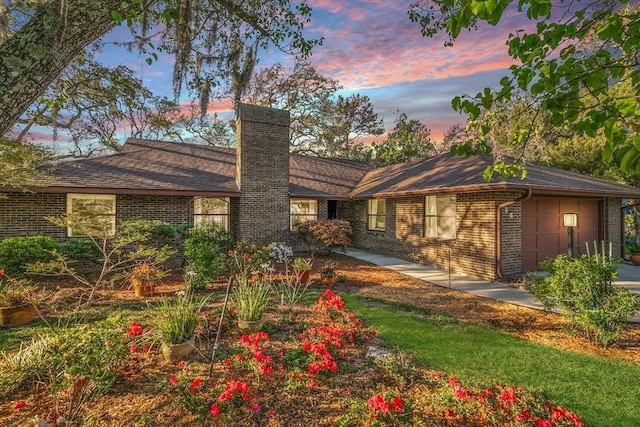 36 Lee Dr, Saint Augustine, FL 32080 - view of front facade with a chimney, an attached garage, and brick siding