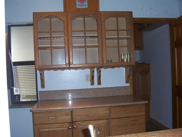 kitchen featuring glass insert cabinets and brown cabinets