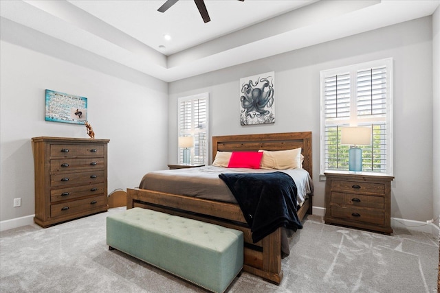 bedroom featuring baseboards, a ceiling fan, carpet flooring, and a raised ceiling