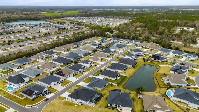 birds eye view of property with a water view, a residential view, and a wooded view