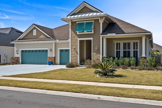 craftsman-style house with metal roof, a garage, driveway, a standing seam roof, and a front yard