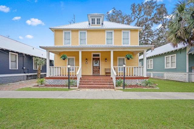 view of front facade featuring a front lawn and covered porch