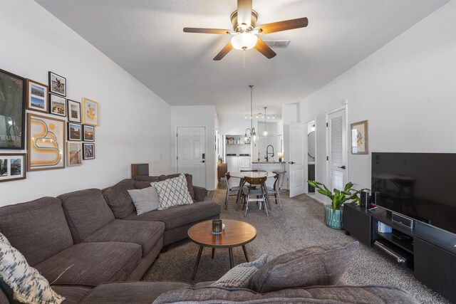 carpeted living room with sink and ceiling fan