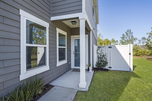 entrance to property featuring a lawn