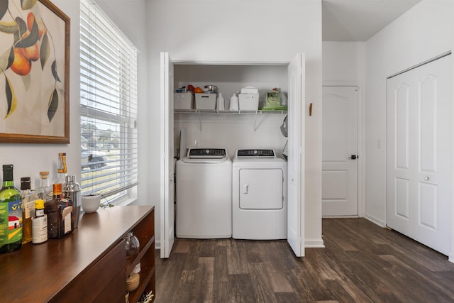 laundry room with washer and dryer, a wealth of natural light, and dark wood-type flooring