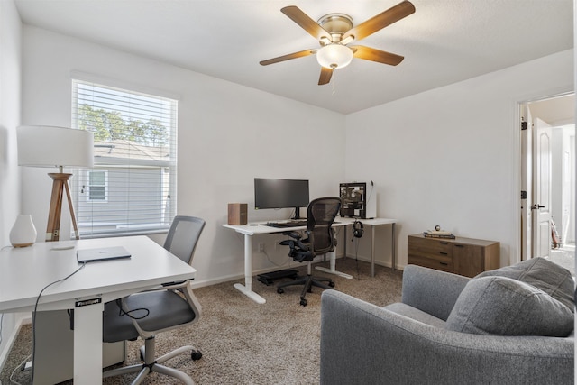 carpeted office space with ceiling fan