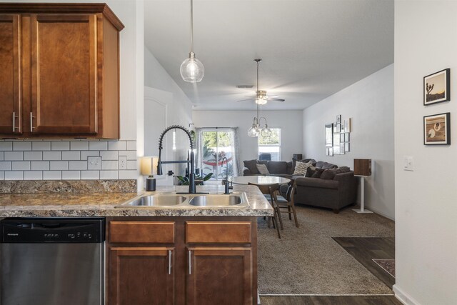 kitchen with dishwasher, dark hardwood / wood-style floors, decorative backsplash, ceiling fan with notable chandelier, and sink