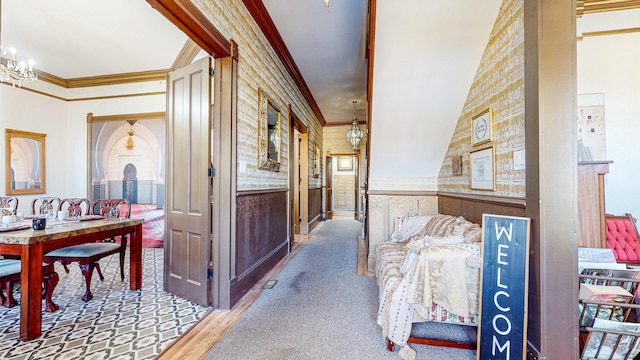 hall featuring a chandelier and ornamental molding