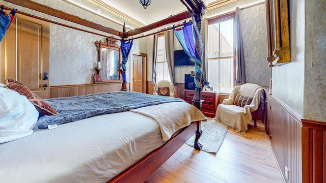 bedroom with crown molding and light hardwood / wood-style flooring