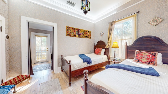 bedroom with crown molding and light hardwood / wood-style flooring