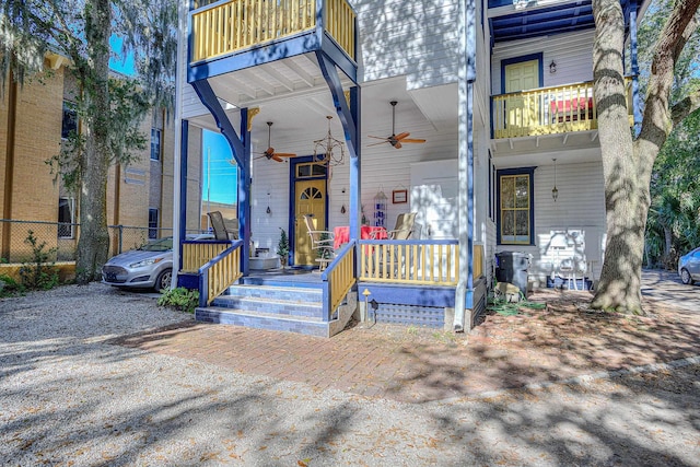 view of front of house featuring ceiling fan, a balcony, and covered porch