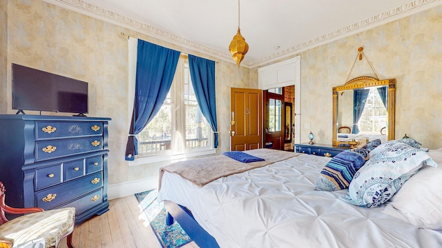 bedroom with light hardwood / wood-style flooring and ornamental molding