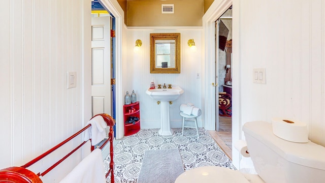 bathroom featuring tile patterned flooring and toilet