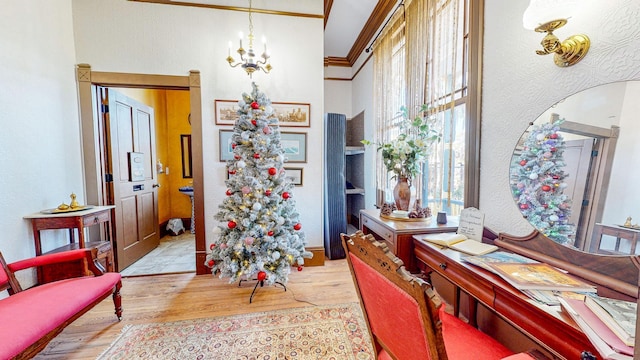 dining area featuring a chandelier, light hardwood / wood-style floors, and ornamental molding