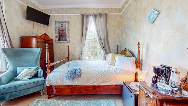 bedroom featuring wood-type flooring and ornamental molding