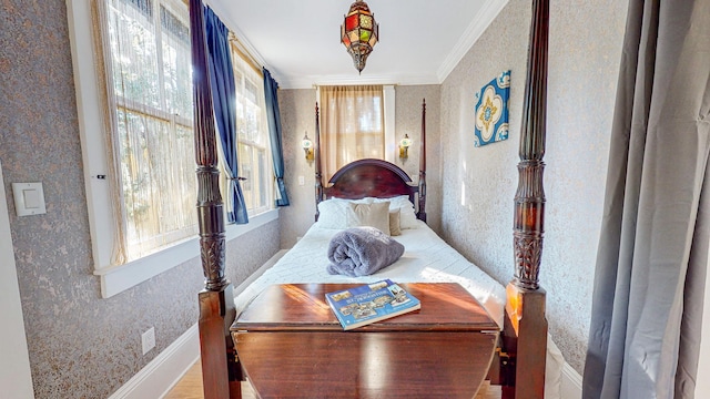 bedroom with crown molding and wood-type flooring